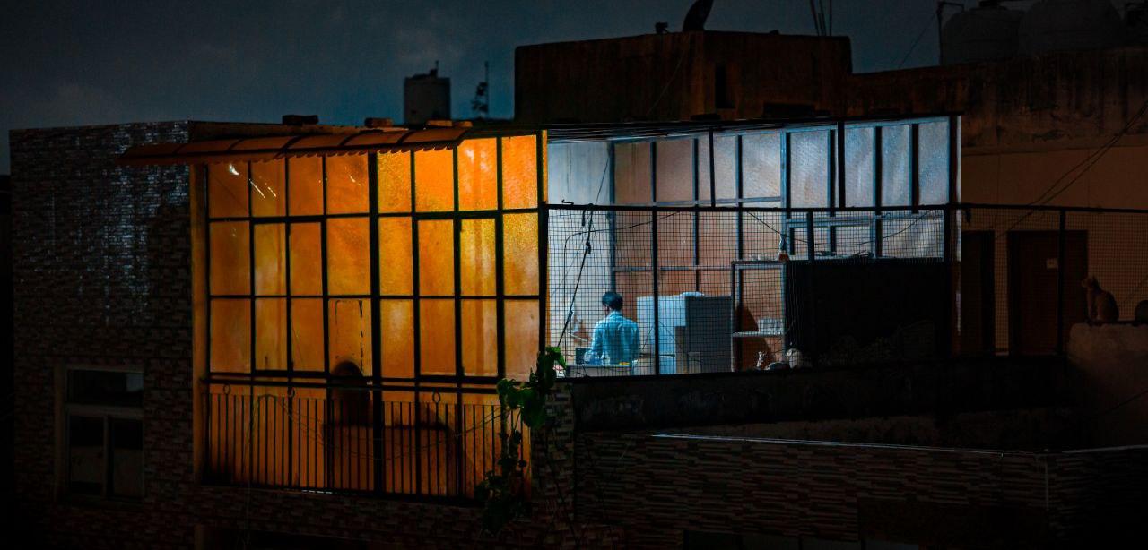 rooftop at night in Delhi - a person is cooking dinner for a mess